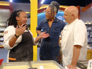 Carla Hall speaking with fellow chefs