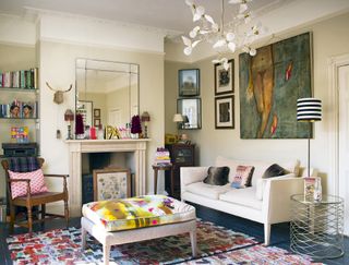 cream living room with eclectic mix of contemporary furniture and antiques and art