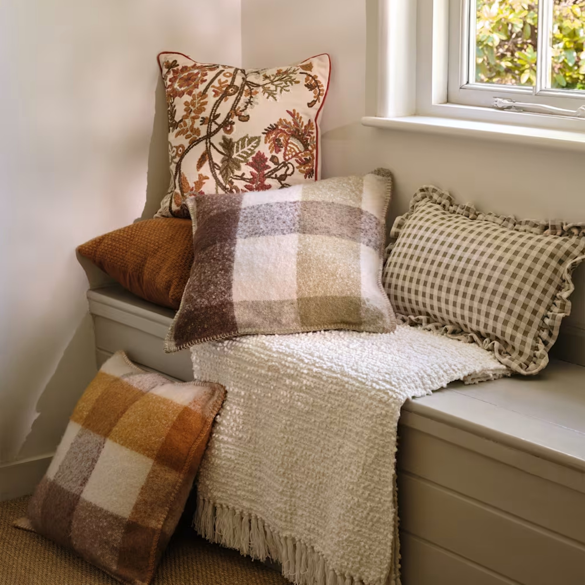 Checked, gingham and floral cushions from Marks &amp;amp; Spencer on a window seat