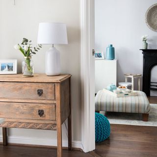 hallway with white wall and wooden floor