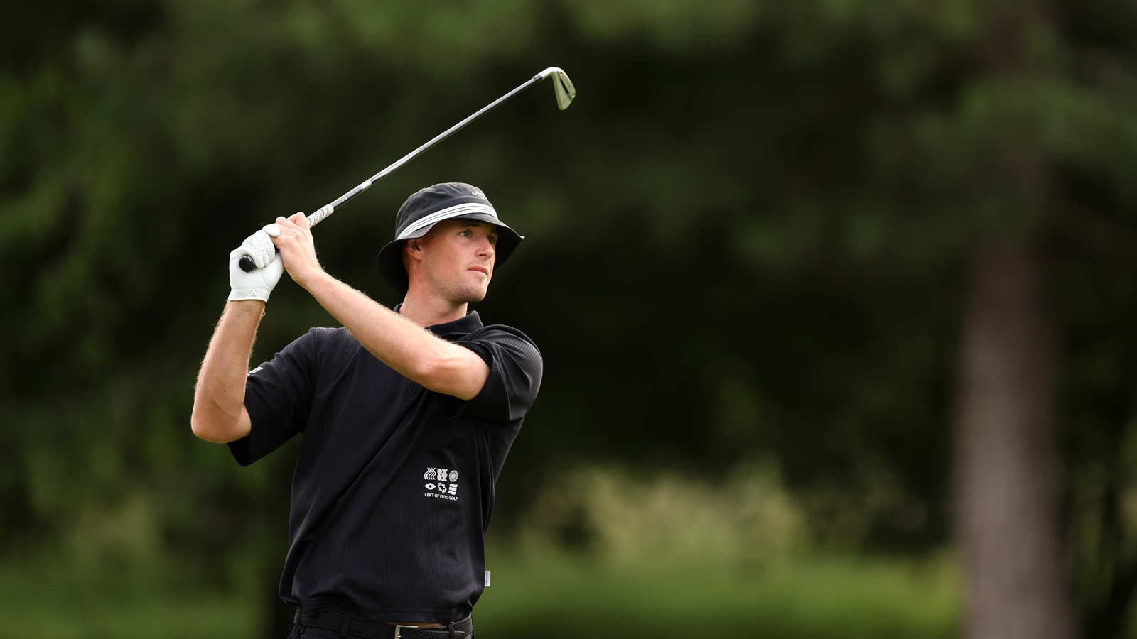 Sam Jones hits an iron shot and watches its flight