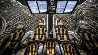 interior of spacex capsule with touchscreens and seven seats