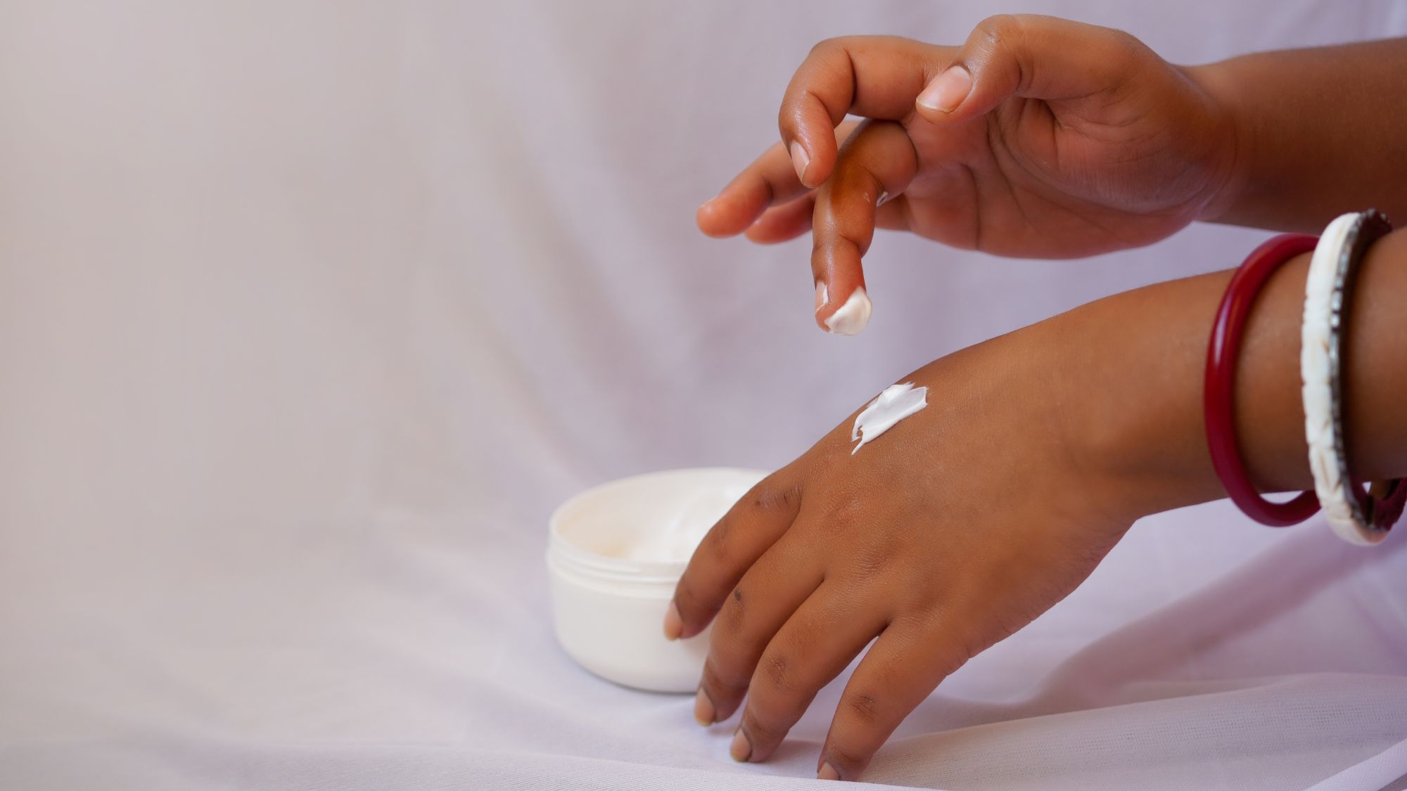 woman applying cream