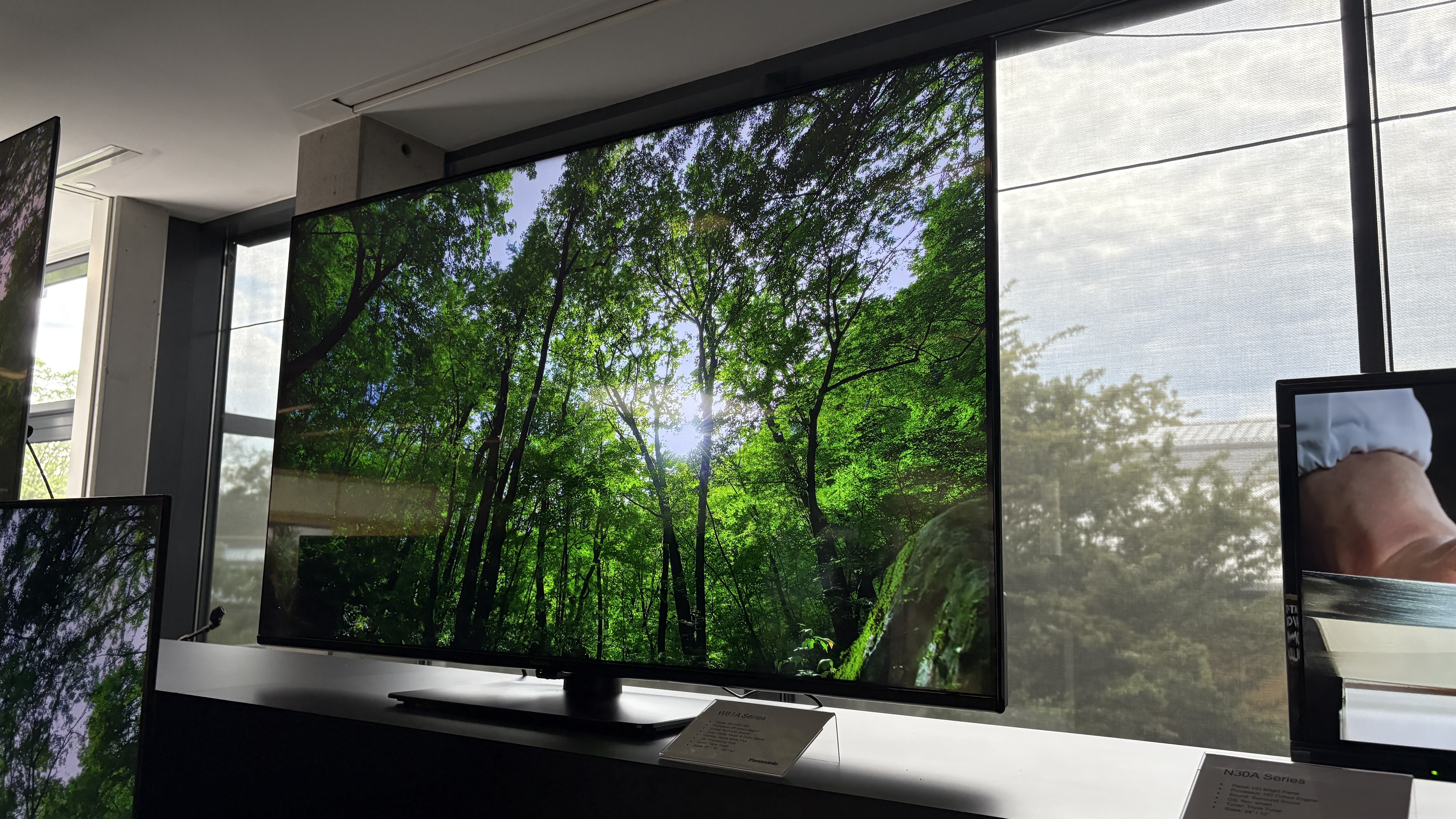 Panasonic TVs on a black show stand