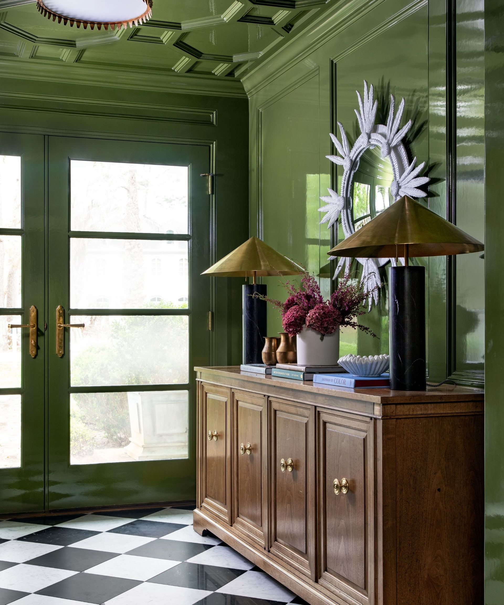 Color drenched green entryway with wooden console