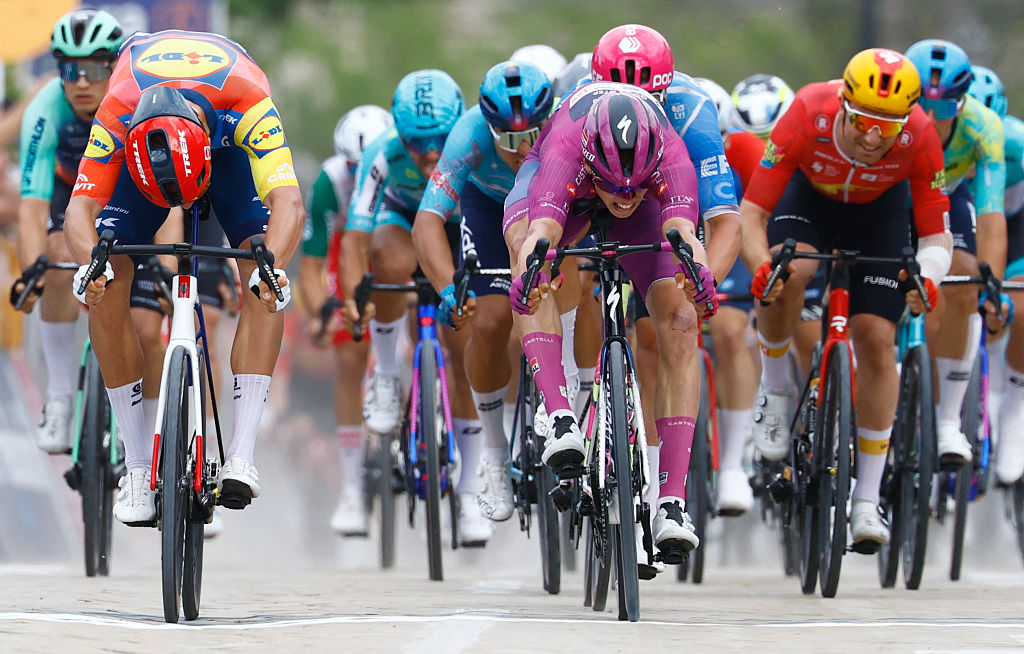 Paul Magnier (C) wearing the points classification mauve jersey (Maglia Ciclamino) sprint to win next to Lidl - Trek Italian rider Jonathan Milan  in the 3nd stage of the Giro d'Italia 2026