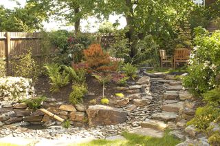 Rock garden with stone steps and outdoor seating area