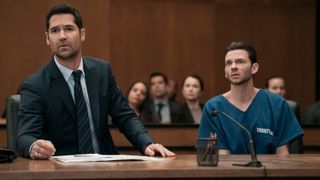 Mickey Haller (Manuel Garcia-Rulfo) and Julian La Cosse (Devon Graye) (L-R) sitting at a table in the courtroom in "The Lincoln Lawyer" season 3