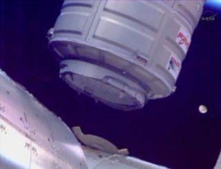 Orbital Sciences' commercial Cygnus spacecraft is seen with the moon in the background as it is installed on the International Space Station on Jan. 12, 2014 during Orbital's first official cargo delivery mission for NASA.