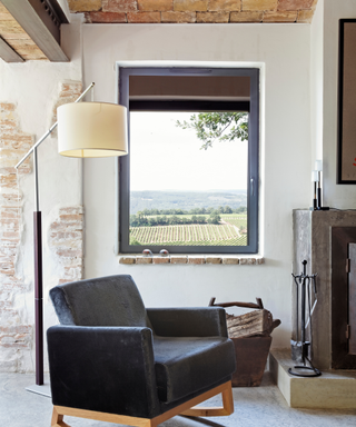 Modern cottage interiors with leather chair in front of window with view