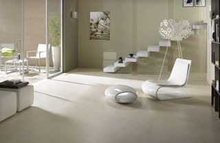 modern living room with stone flooring, white floating staircase, white modern furniture
