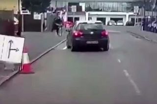 Volkswagen Gold swerves onto the pavement to strike a man riding a bike