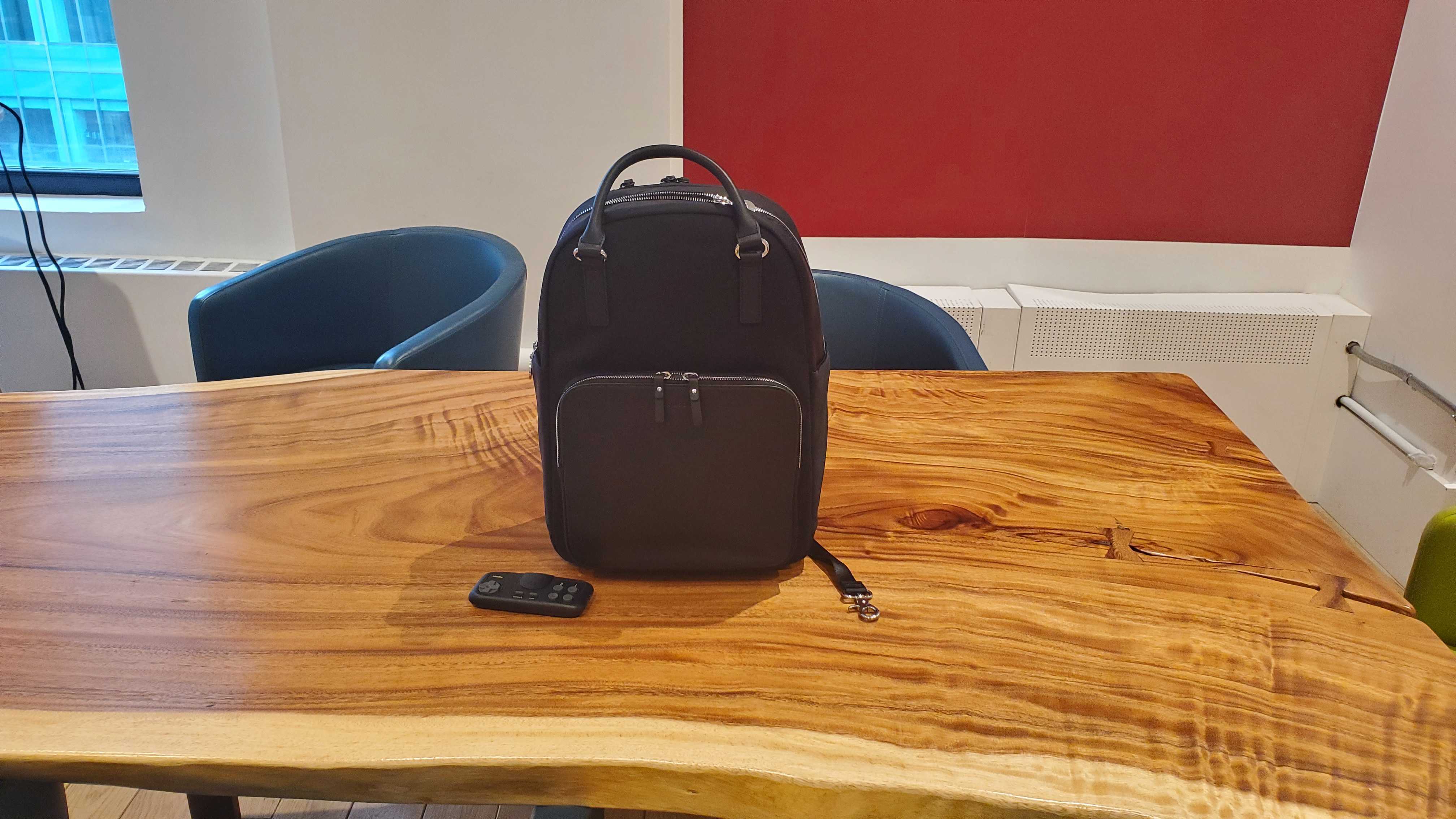 black laptop backpack sitting on a wooden table