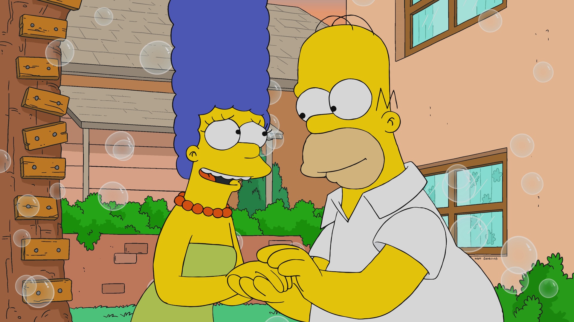 Homer and Marge Simpsons holding hands with bubbles in the background