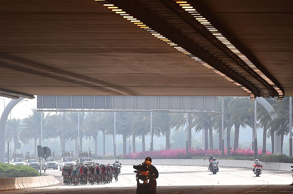 The peloton race under a bridge Abu Dhabi Tour