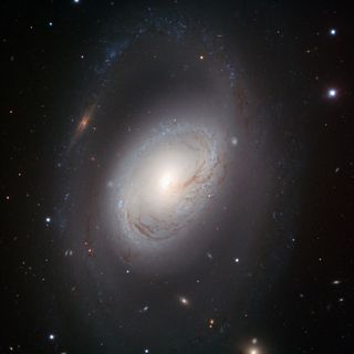 Spiral galaxy Messier 96 has a core displaced from the center, gas and dust distributed asymmetrically and ill-defined spiral arms.