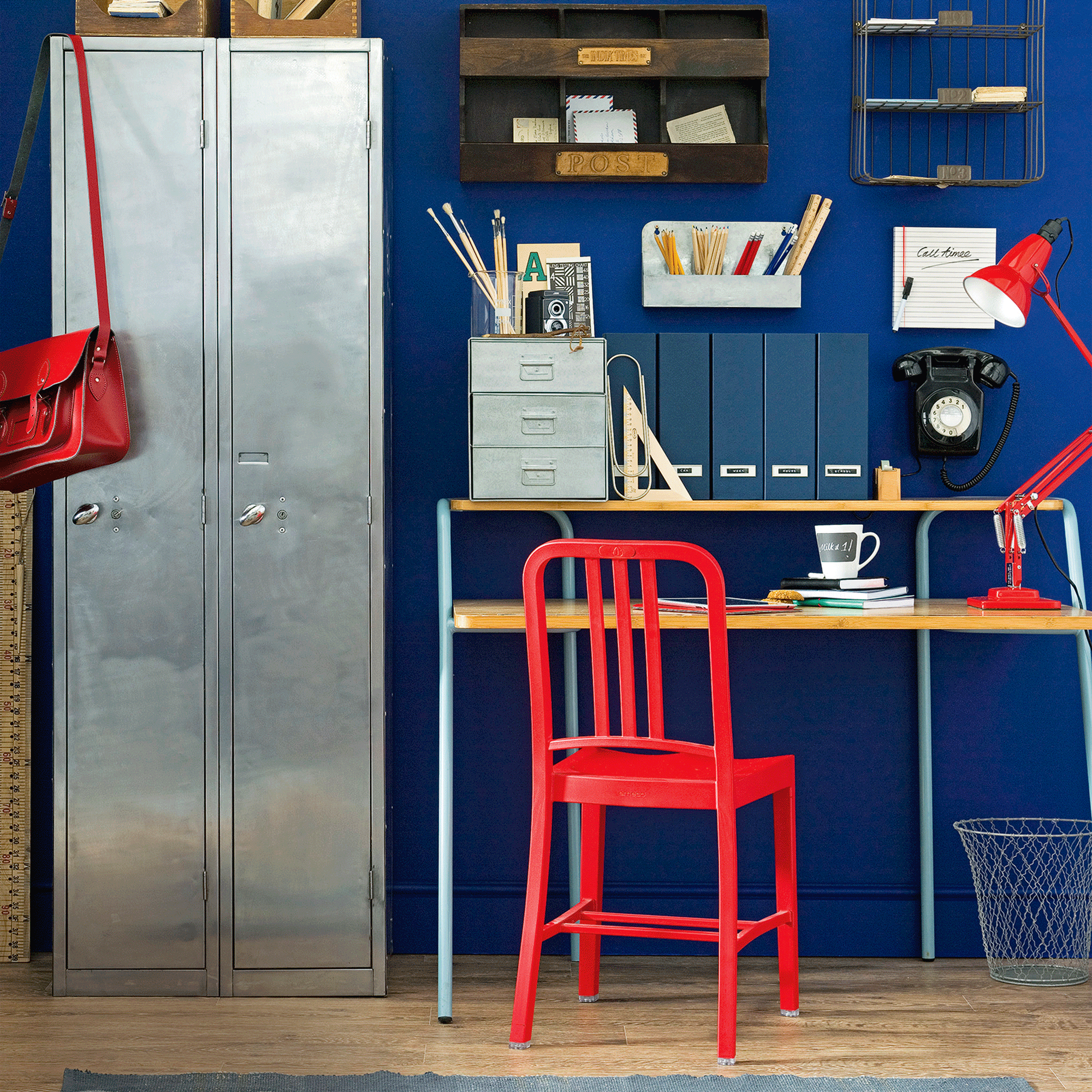 Blue office with metal locker and red chair