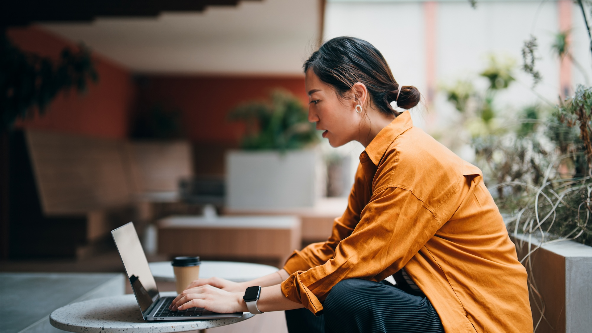Woman working on laptop at desk