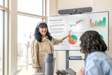 Educator pointing at charts on board