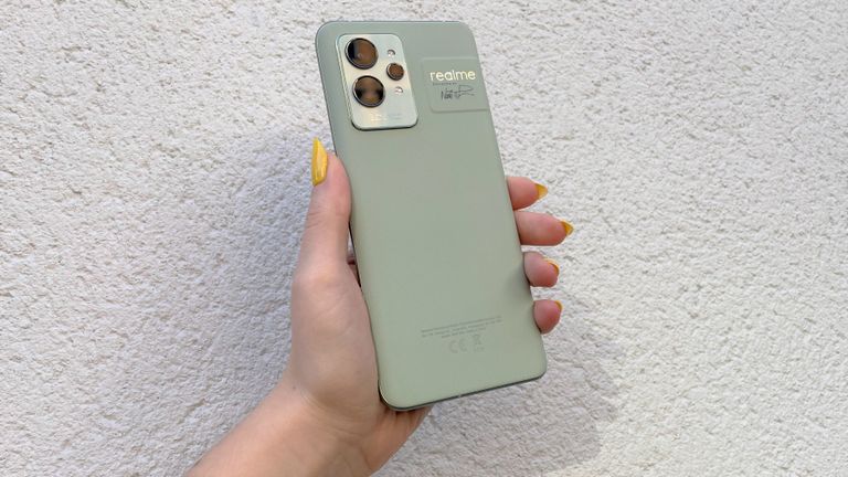 Realme GT 2 Pro review: phone being held up against a white wall