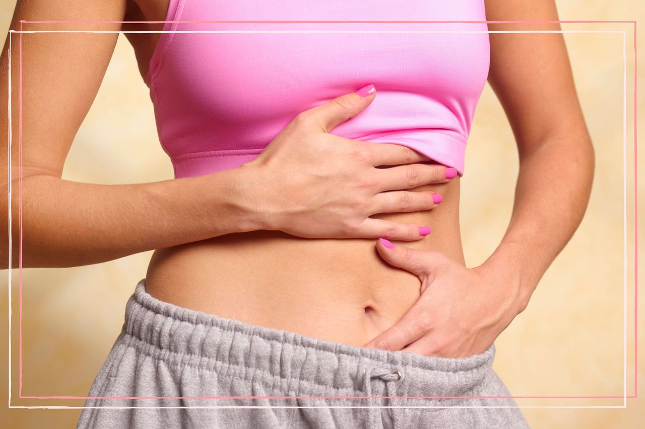 A close up of a woman holding her stomach