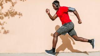 Running headphones deals: Image of man running with headphones