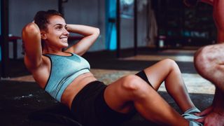 a photo of a woman doing butterfly crunches