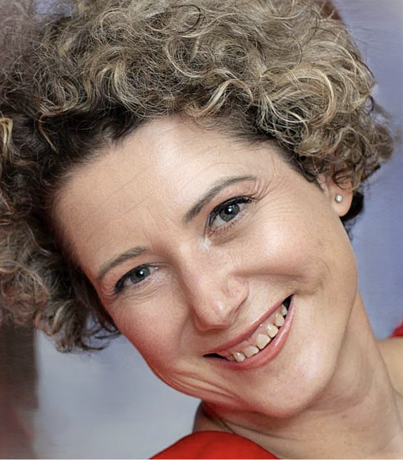 woman smiles to camera in red top