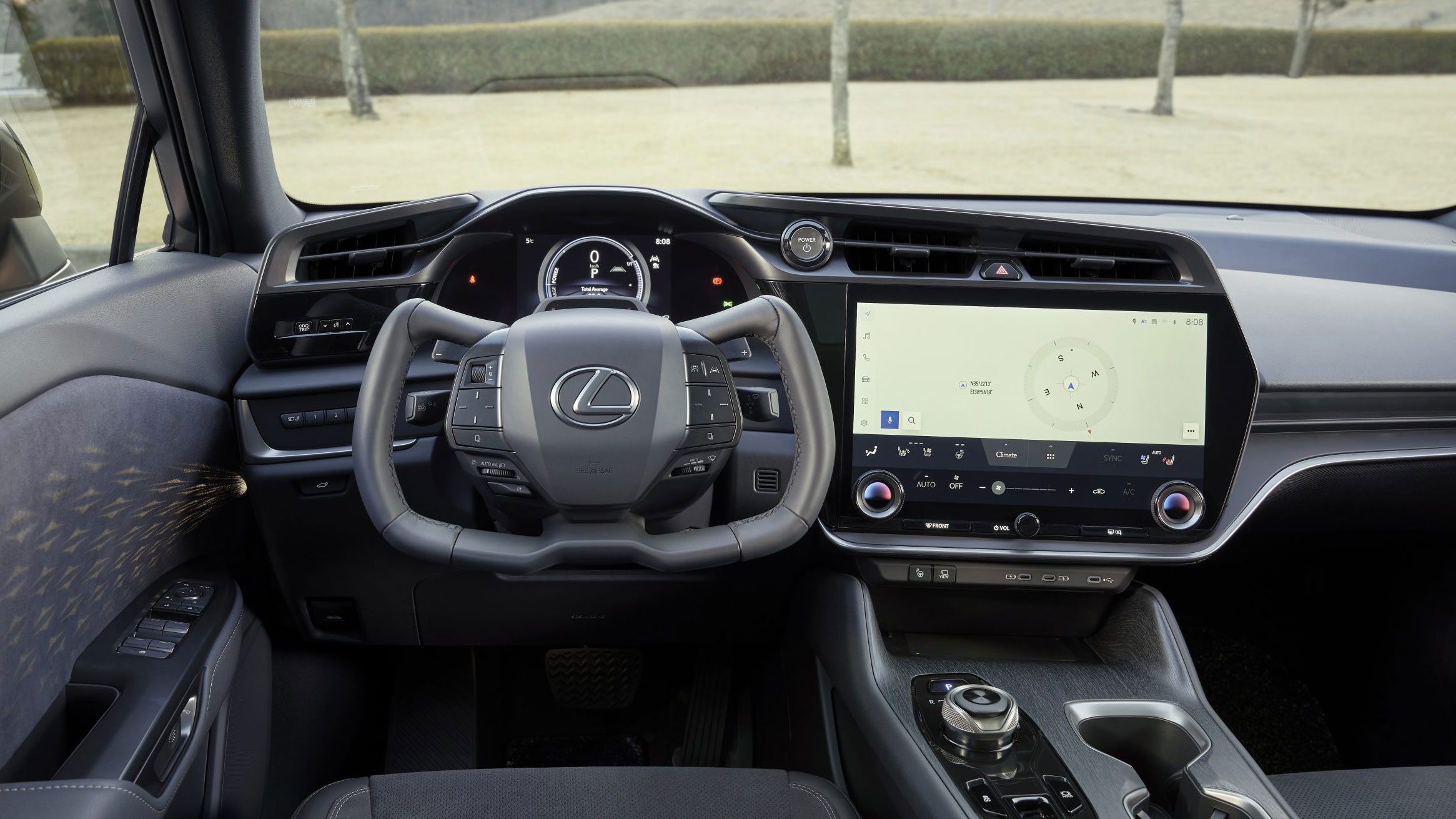 Driver's view of the yoke steering wheel and large central display in the Close-up of yoke steering wheel in the Lexus RZ 450e