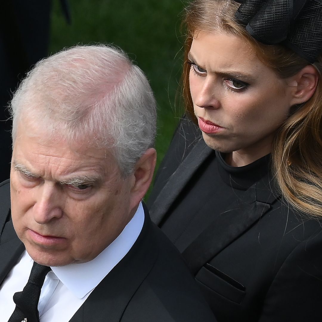 Prince Andrew looks stern wearing a suit and Princess Beatrice wears a black dress