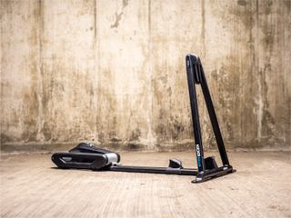 A Wahoo Kickr Rollr smart turbo trainer stands in an underground car park