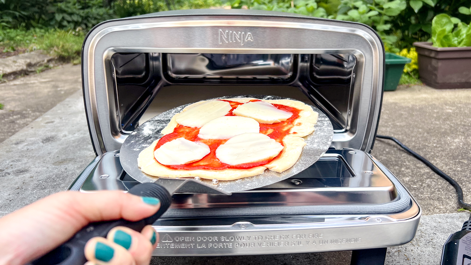 Ninja Artisan Outdoor Pizza Oven in a back yard