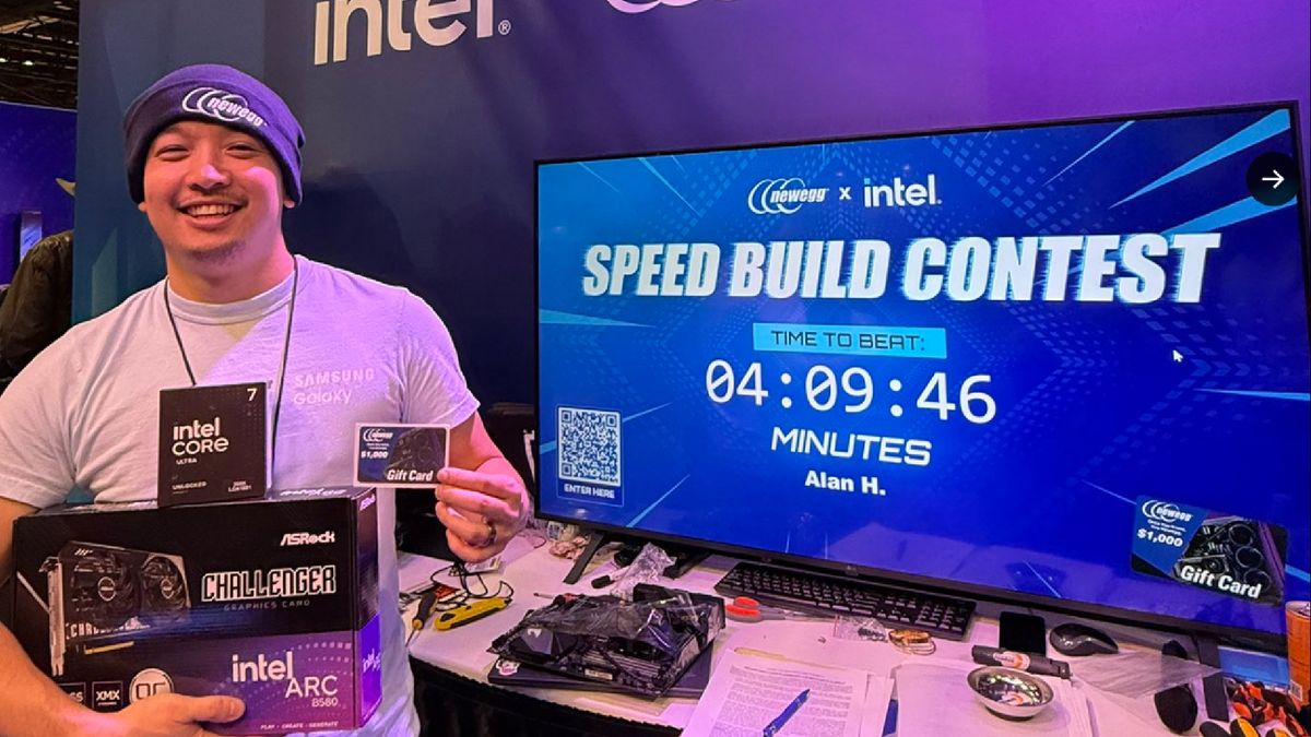 A photo of a winning competitor at Newegg&#039;s PC speed building contest, next to a screen displaying their time.