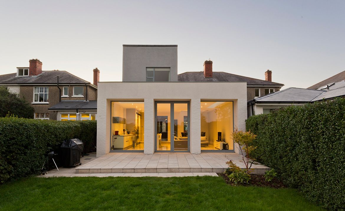 A house with glass window and green lawn 