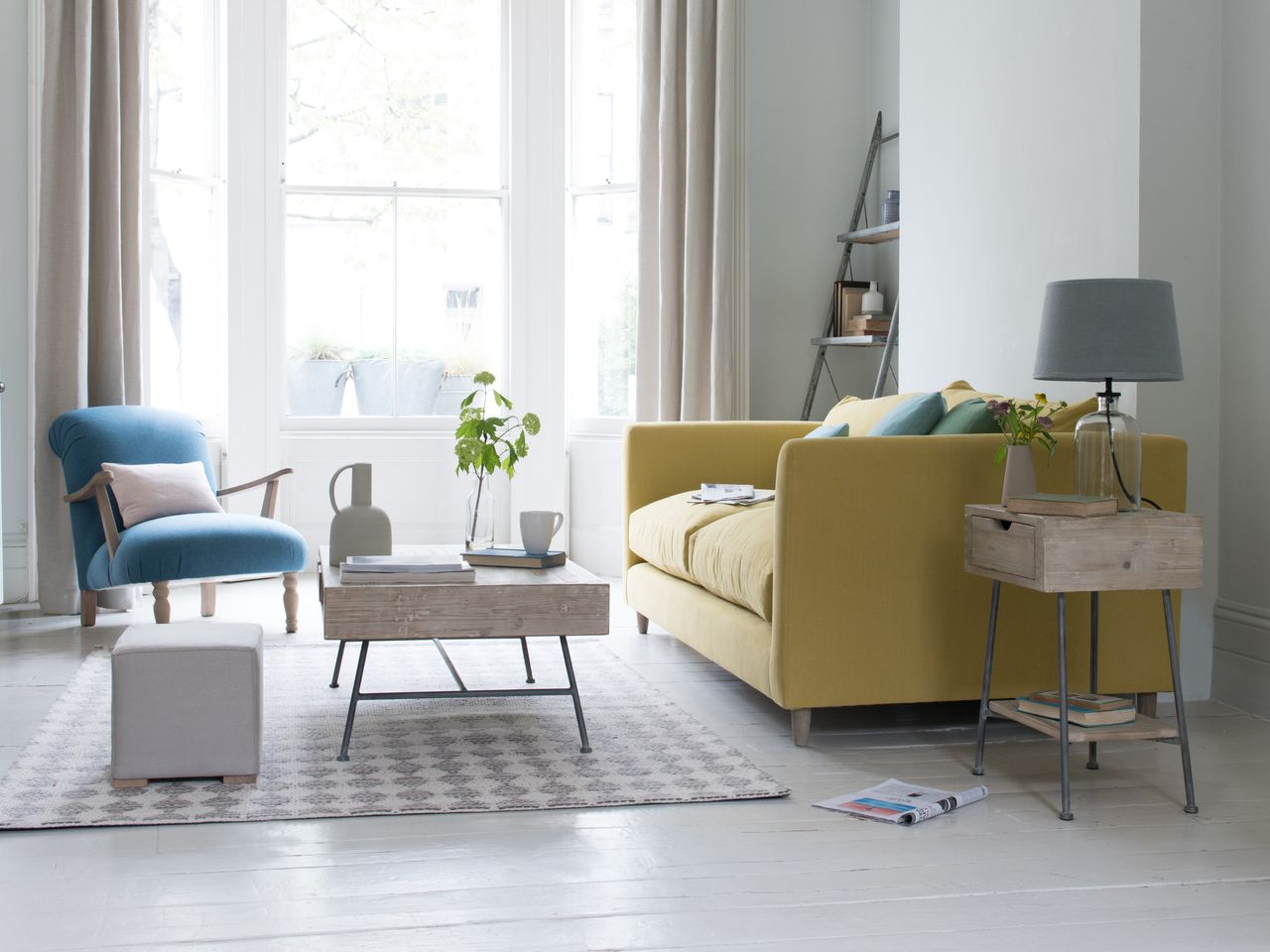 living room with white scheme and yellow sofa by loaf