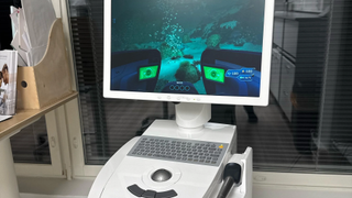 A 3D dental scanner being used to play Subnautica with keyboard and trackball.