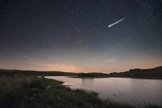 an image of a meteor streaking above a river in Spain