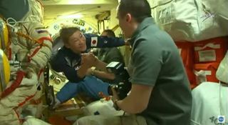 Japanese entrepreneur Yusaku Maezawa enters the International Space Station to begin a 12-day space tourist trip following a Soyuz launch and docking on Dec. 8, 2021.