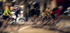 A blurred image of cyclists commuting in a city