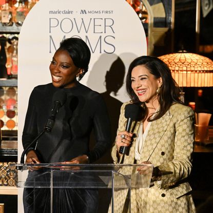 Nikki Ogunnaike and Reshma Saujani speak at a podium