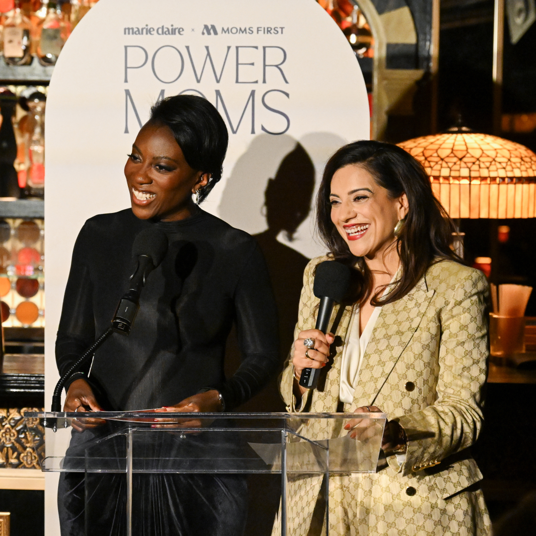 Nikki Ogunnaike and Reshma Saujani speak at a podium