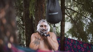 A man enjoying an outdoor shower