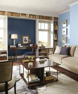 blue living room with beige sofa and wooden furniture