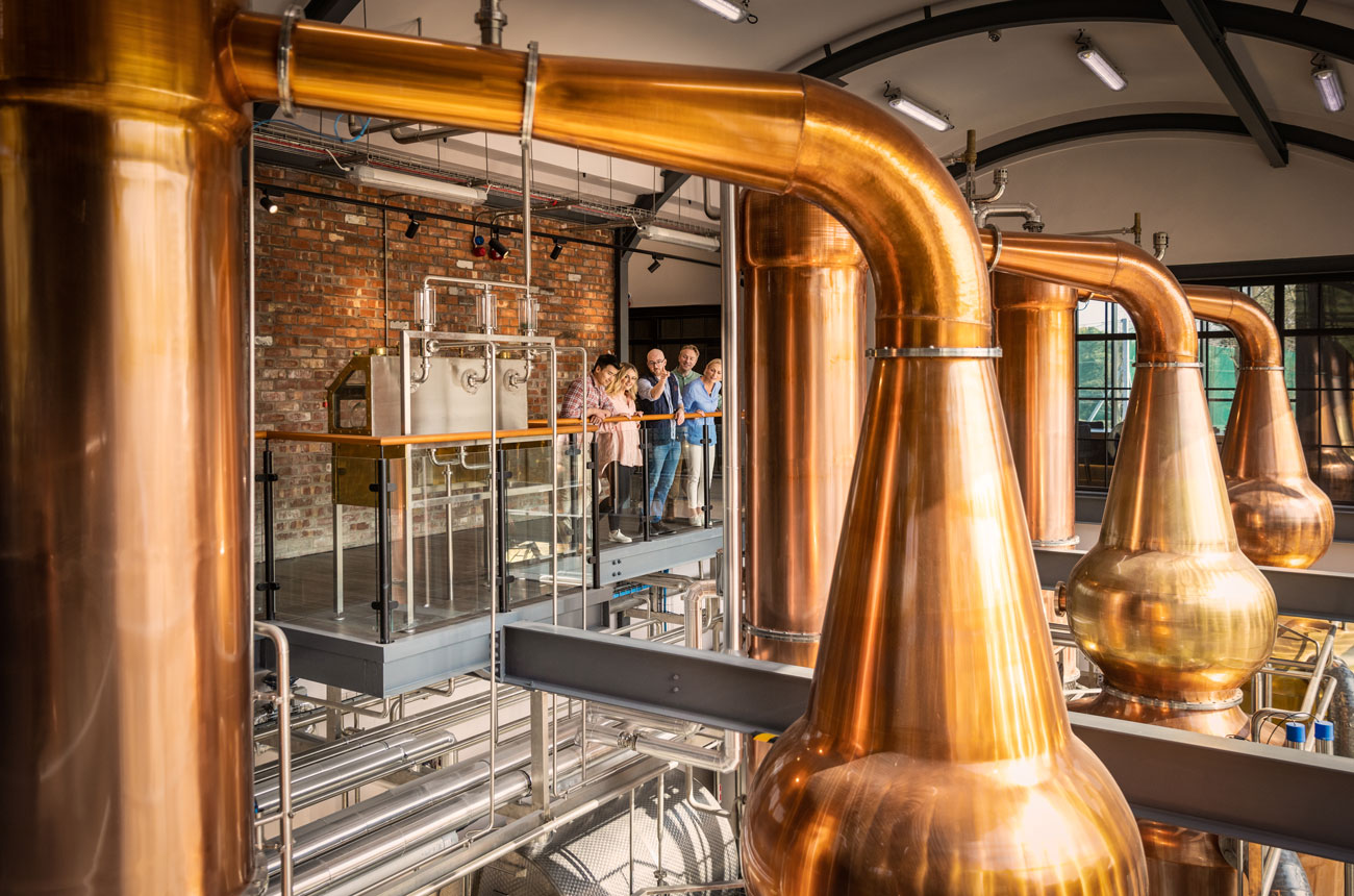 Visitors take a tour at Hinch Distillery