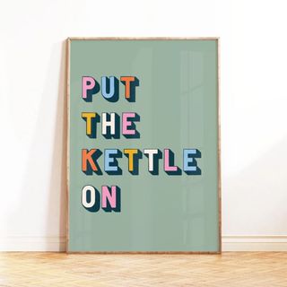 A mostly pastel green print with multi-coloured bold lettering saying Put The Kettle On 
