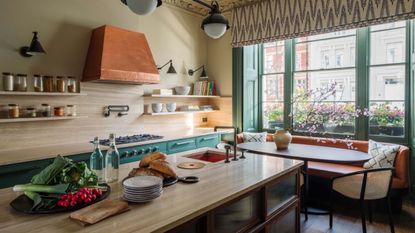 kitchen diner with island and window seating and copper extractor