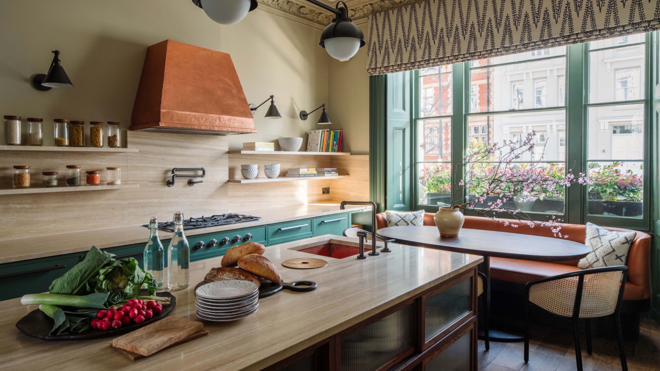 kitchen diner with island and window seating and copper extractor
