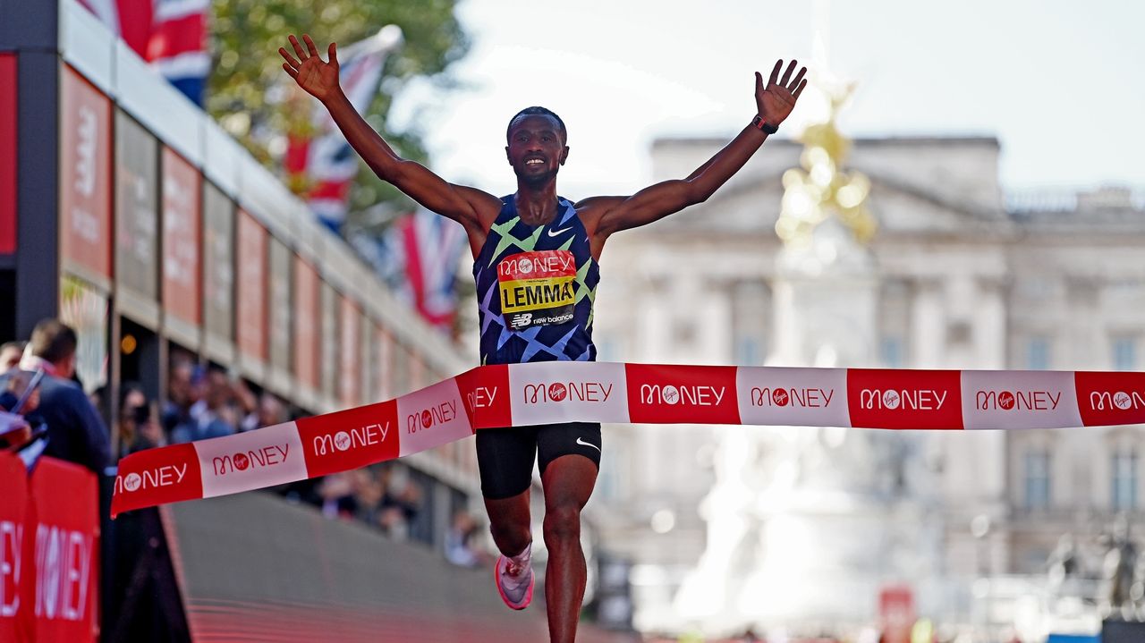 LONDON, ENGLAND - OCTOBER 03: Sisay Lemma of Ethiopia celebrates winning the Men&#039;s Elite race during the 2021 Virgin Money London Marathon at Tower Bridge on October 03, 2021 in London, England.