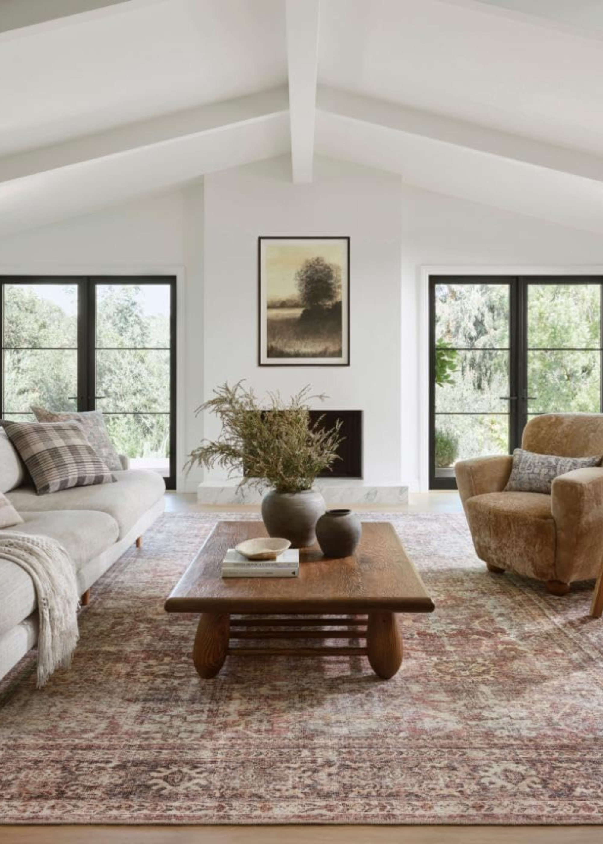 loloi x amber lewis rug in a neutral living room with a sofa, coffee table and armchair