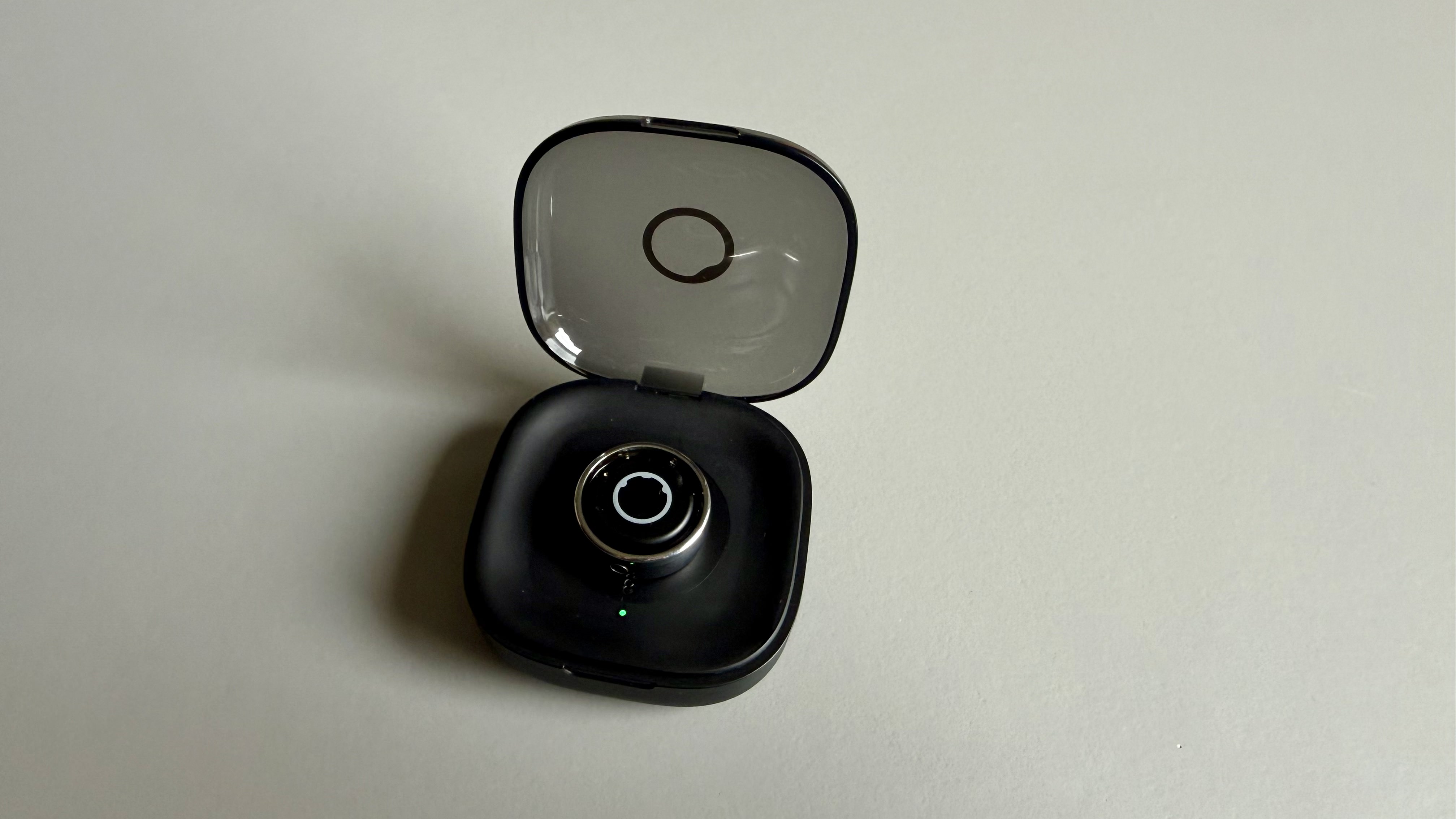 The circular ring 2 smart ring pictured in its charging case